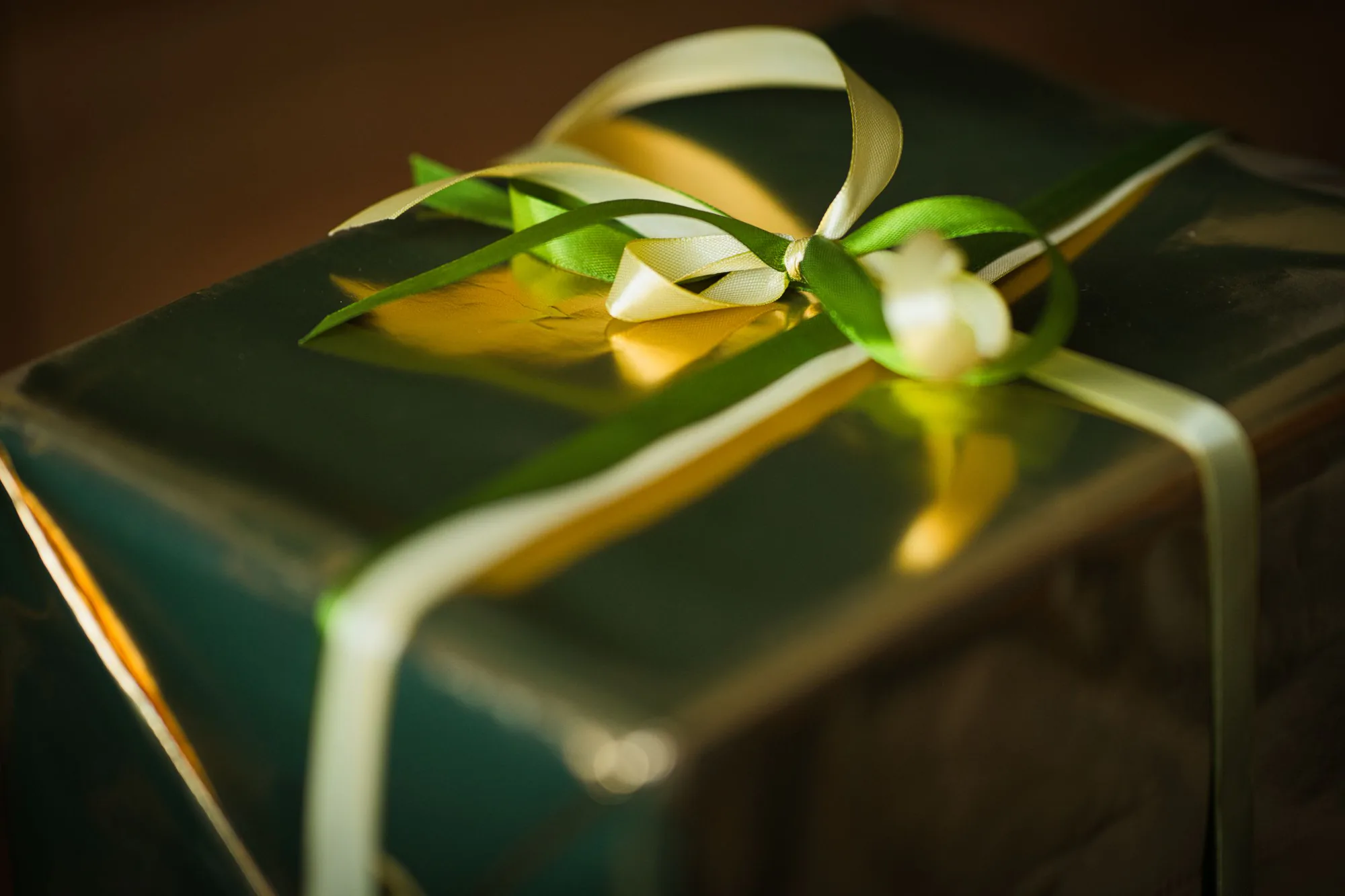 Luxury green gift box finished with gold and ivory ribbon